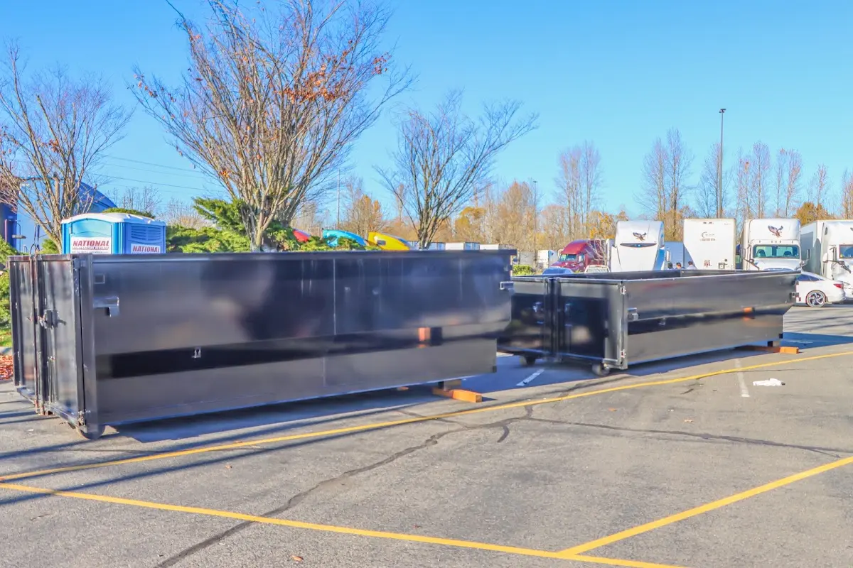 Professional dumpster rental service with roll-off container on residential driveway in Jeffersonville